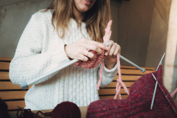 istock Close up on woman's hands knitting 1165800283