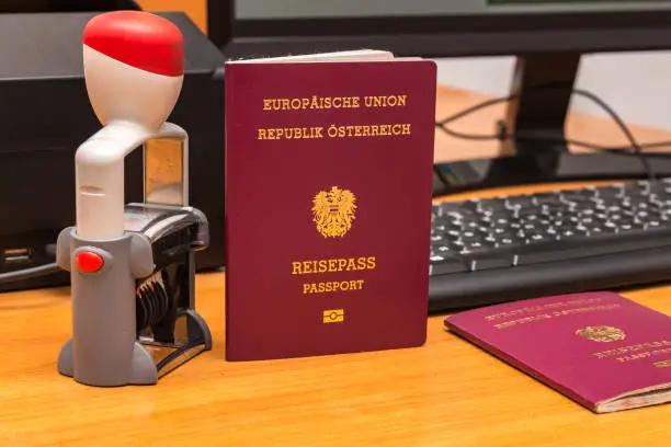 Close-up of Austrian biometric passport with a date stamper, interstate border in Europe. Inscription - European Union, Republic of Austria, Passport. Border crossing, travel, immigration concept