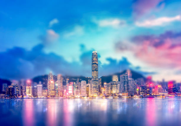istock Abstract bokeh light with Hong Kong City night view background; Double Exposure 1165800420