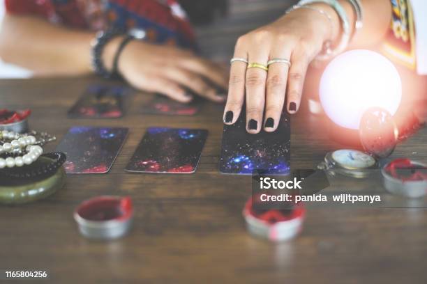 Tarot Cards Reading Divination Psychic Readings And Clairvoyance Concept Crystal Ball Fortune Teller Hands Stock Photo - Download Image Now