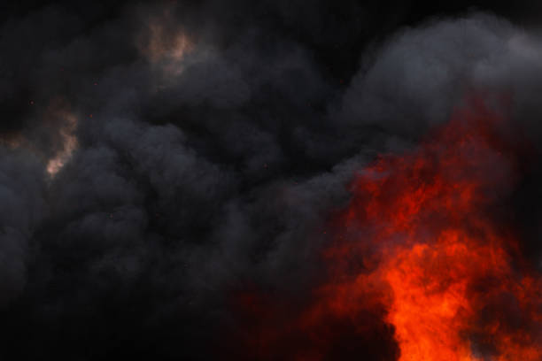 istock Flames strong red industrial fire, dramatic clouds of black smoke covered sky 1165819271