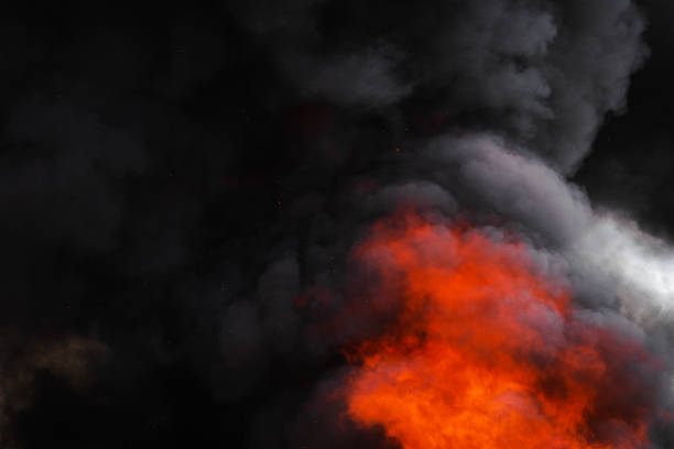 istock Flames strong red fire, dramatic clouds motion blur of black smoke covered sky 1165819277