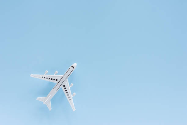 istock White airplane model on blue background for vehicle and transportation concept 1165819301