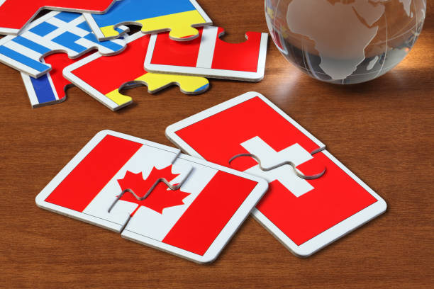 istock Canada and Swiss Flags in puzzle 1165822028