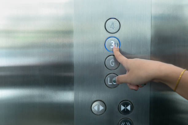 istock Close up waman hand press a up button of elevator. 1165822129