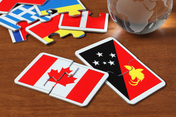 istock Canada and Papua New Guinea Flags in puzzle 1165824294