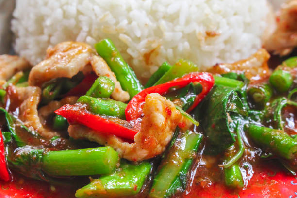 istock Stir fried pork with red curry paste and organic kale , Thai food 1165826007