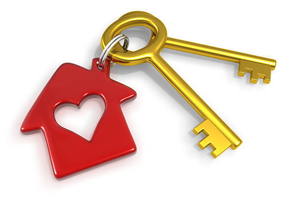 3d rendered two keys with trinket in the form of house with heart on white background