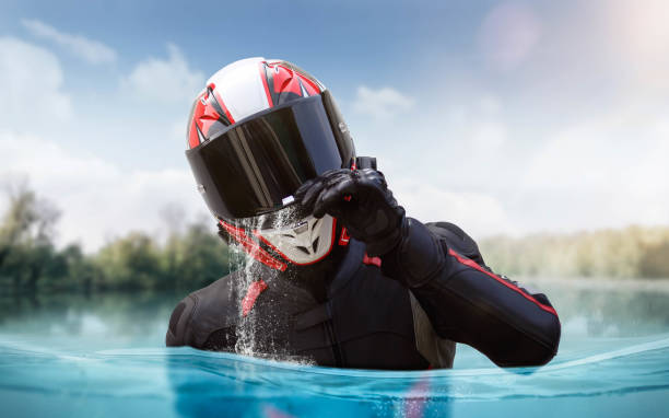 Palangka Raya City, Central Kalimantan Province, Indonesia - January 18, 2023 - The image of a motorcyclist crossing an asphalt road that is flooded with water when it rains.