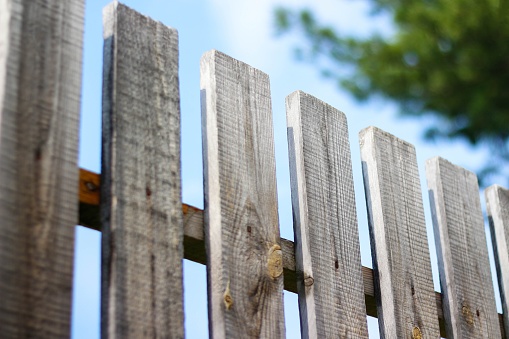 Wooden fence. Close up. Against the blue sky.