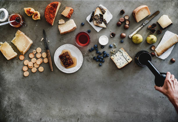 Snacks and female hands pouring wine to glass, copy space