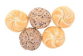 Kaiser roll, brown bun and bun with pumpkin seeds isolated on white background. Top view.