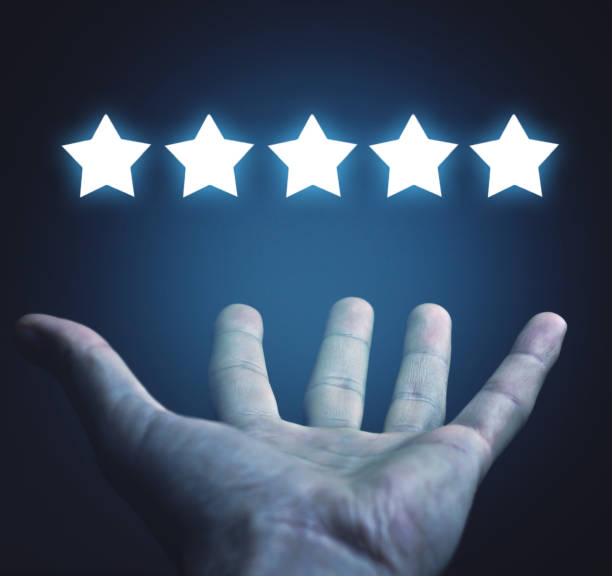 istock Male hand holding five stars. Rating. Customer satisfaction 1165837568