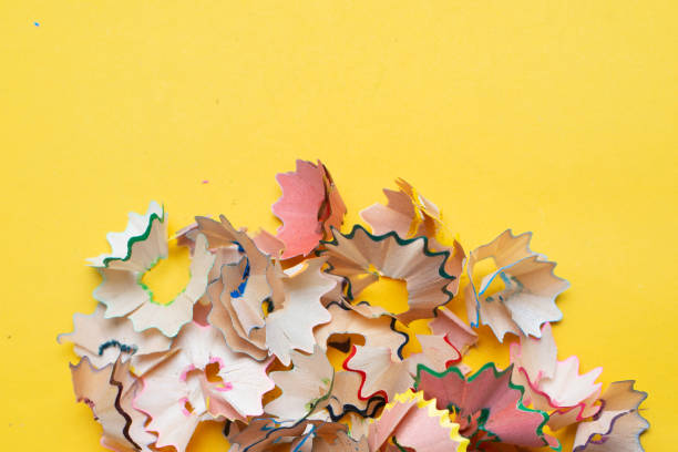 istock Colorful pencil shavings on yellow background. Back to school concept. Copyspace. 1165837593