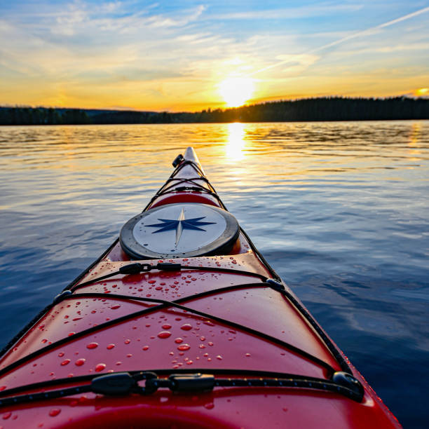 red plastic kayak on calm water in the sunset Filipstad july 31 2019