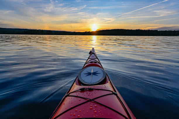 istock red plastic kayak on calm water in the sunset 1165838673