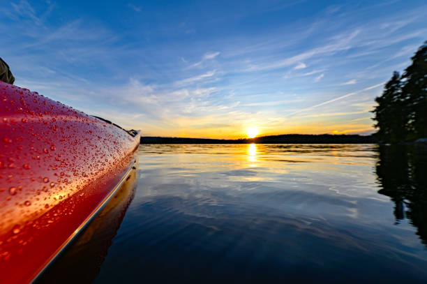 istock red plastic kayak on calm water in the sunset 1165839184