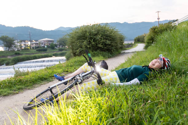 Senior woman falling down from her bike