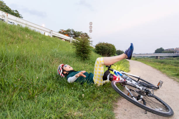istock Senior woman falling down from her bike 1165841114