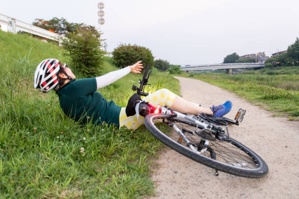 istock Senior woman falling down from her bike 1165841125