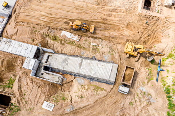 istock excavator loading ground into a dump truck on road construction site 1165841230