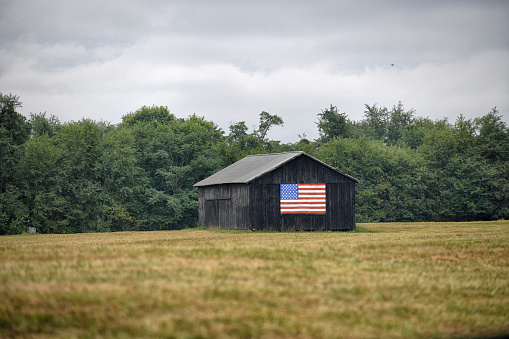 Barn with an American flag painted on the side.