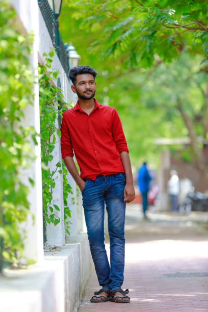 istock Indian / Asian Collage boy in red shirt and Showing expression 1165852515