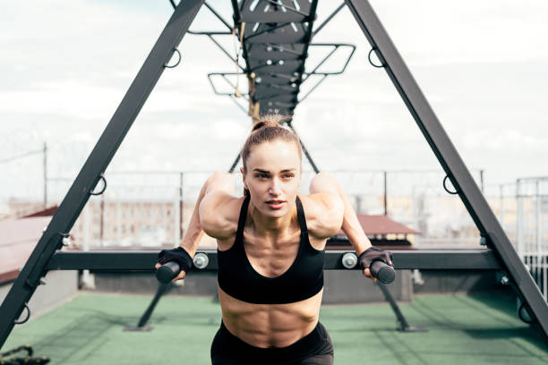 istock Fitness woman doing triceps dip using power rack on a terrace 1165853120