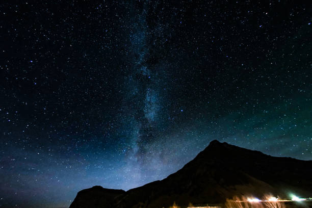 istock Mountain silhouette and starry sky (Iceland) 1165854098