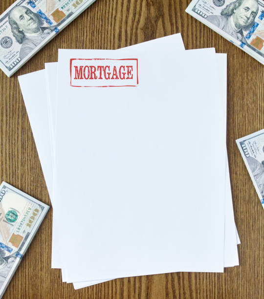 Mortgage concept Looking down on wooden desk with blank paper with mortgage stamp 100 dollar bills one hundred dollar stamp stock pictures, royalty-free photos & images