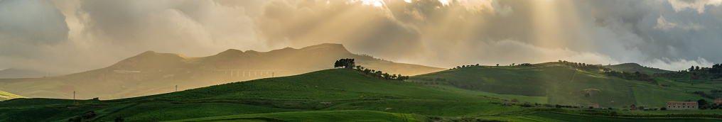Suggestive view on Italian countryside hills in Sicily, Italy, with sunlight from above