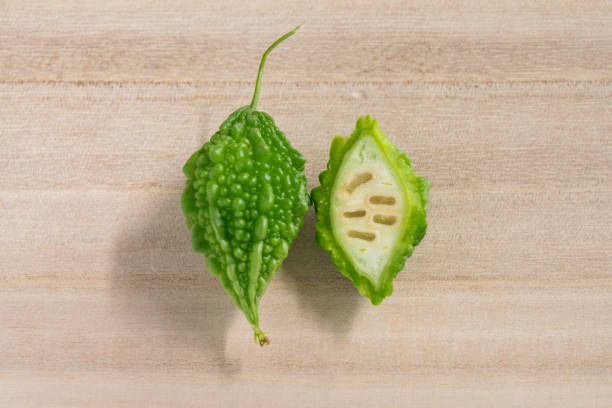 The bitter gourd bitter gourd isolated on wooden background dissected flower stock pictures, royalty-free photos & images