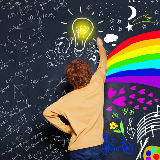 istock Occupation choice. Kid drawing science formula and art pattern on blackboard background 1165858659