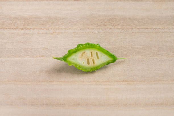 The bitter gourd bitter gourd isolated on wooden background dissected flower stock pictures, royalty-free photos & images