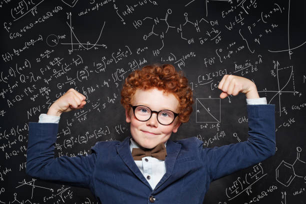 istock Happy strong child boy on chalkboard background. Back to school concept 1165858703