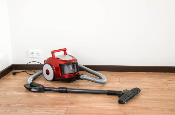 istock vacuum cleaner is standing on the floor 1165859813