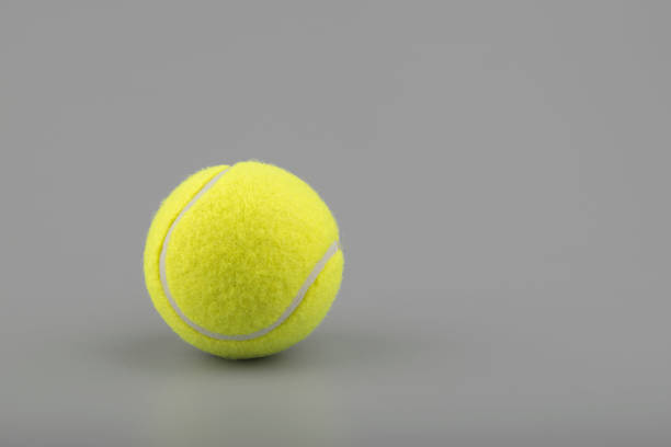 istock tennis ball on grey background 1165860544