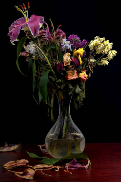 istock vase of withering flowers 1165861392