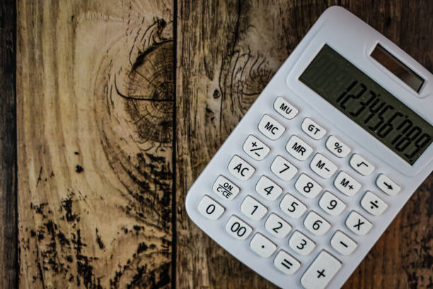 istock Calculator placed on a wooden table 1165861617