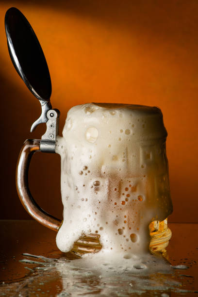 fresh and frothy beer overflowing from the glass mug