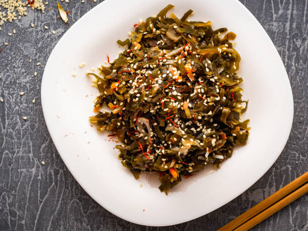 istock Seaweed salad with sesame seeds is on a white plate 1165866744