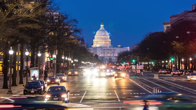 Time-lapse: US Capitol Building with transportation light from Freedom Square in Washington DC, USA at sunset twilight