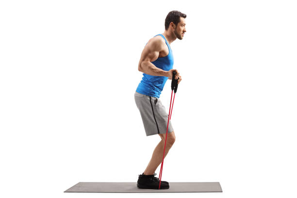 istock Man on an exercise mat with a resistance band 1165871863
