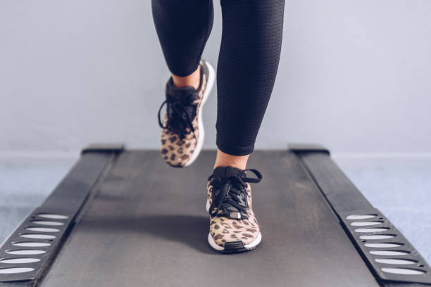 istock Fitness girl running on treadmill. 1165871879
