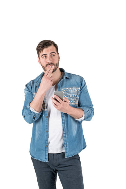 istock Thoughtful young man with smartphone, isolated 1165874181