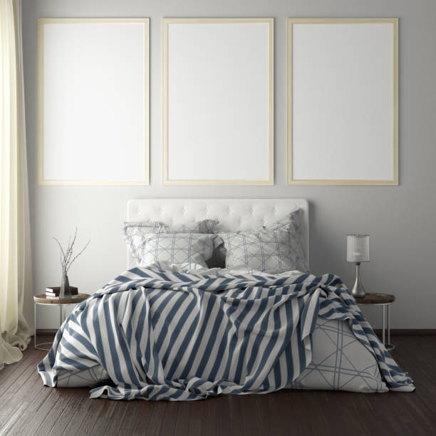 istock poster frame mockups above the bed on the wall in bedroom 1165875076