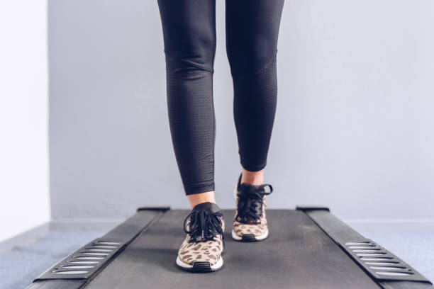 istock Fitness girl running on treadmill. 1165875142