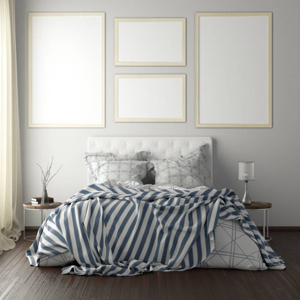 istock poster frame mockups above the bed on the wall in bedroom 1165875144
