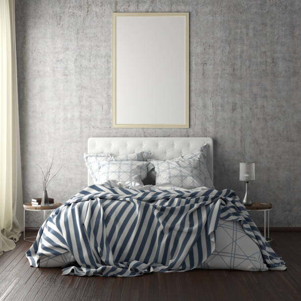 istock poster frame mockups above the bed on the wall in bedroom 1165875310