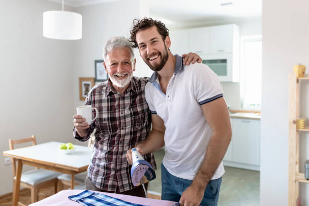 istock Son Ironing Shirts of His Elder Father 1165876387
